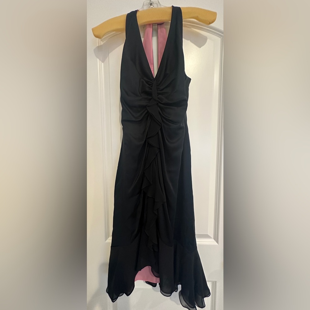 Beautiful silky sleeveless midi dress. Black silk with pop of pink lining.